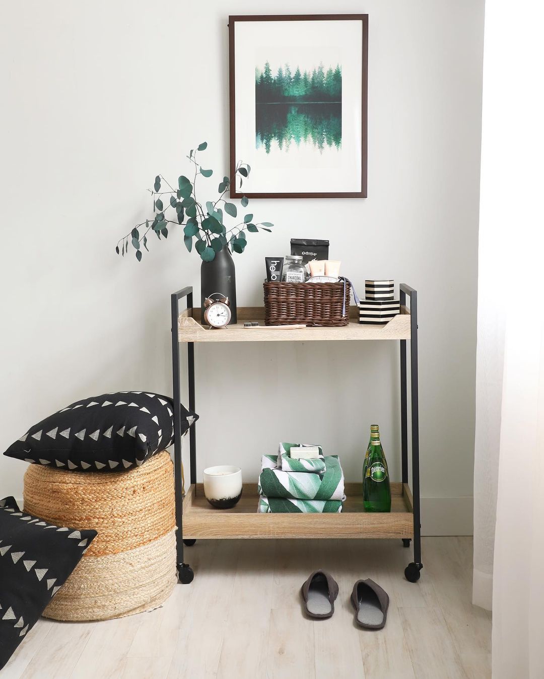 A wooden and metal cart on wheels and a storage basket provide clever storage options for a more efficient use of space.
