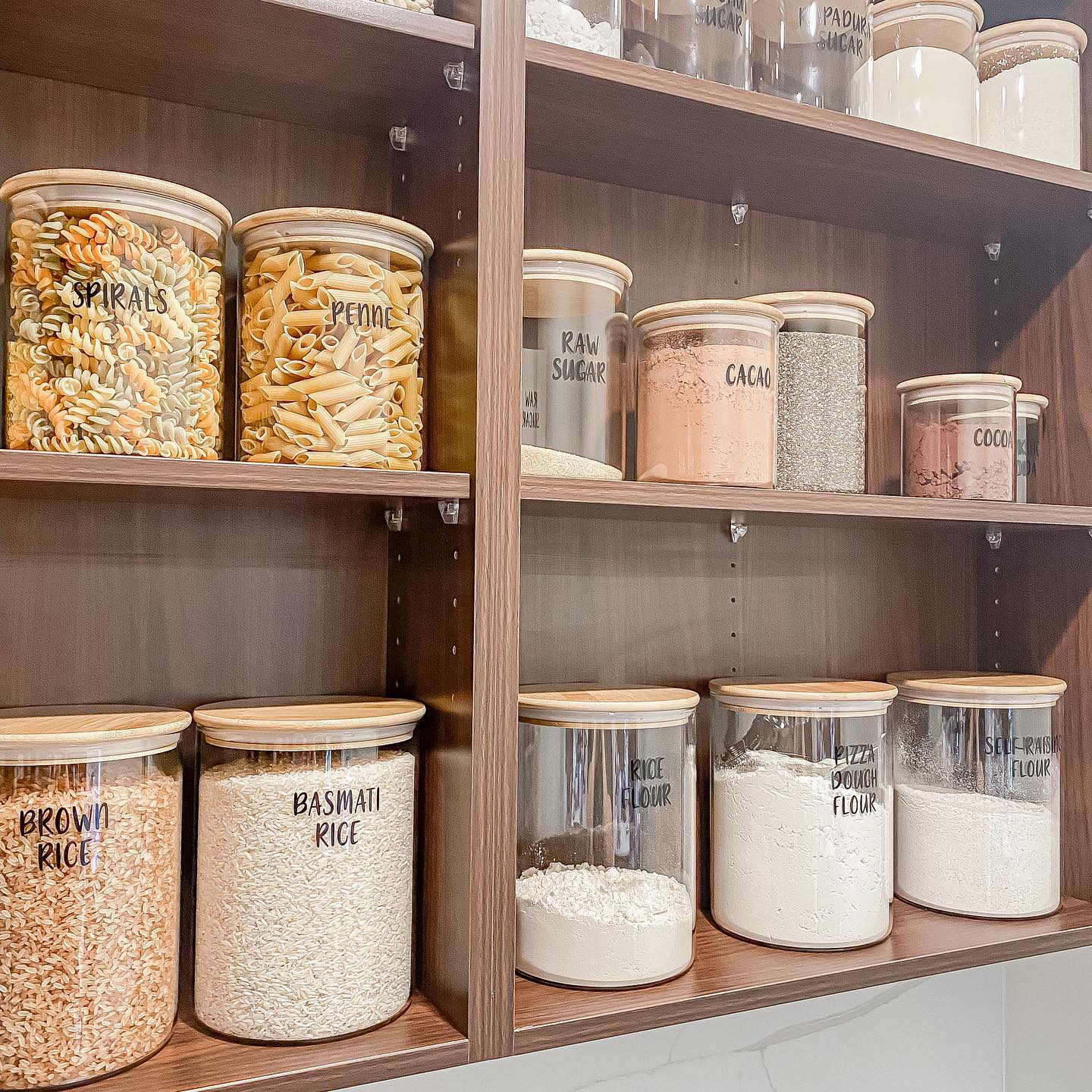 A kitchen with jars filled with cereals and other foods, perfect for organization.