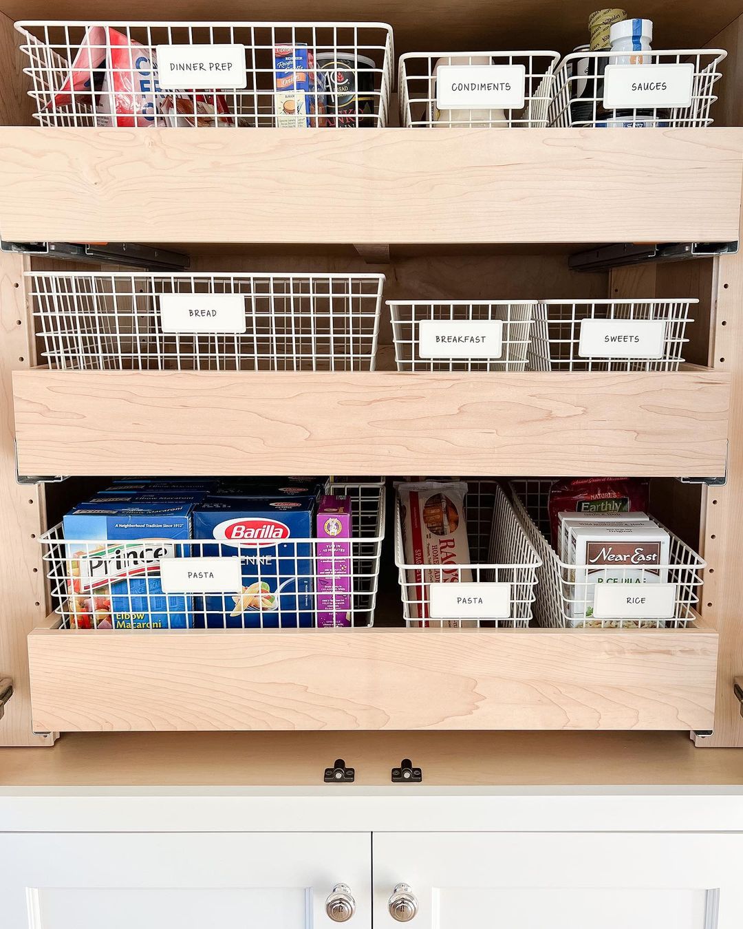 Organize your pantry with wire baskets filled with food for maximum efficiency.
