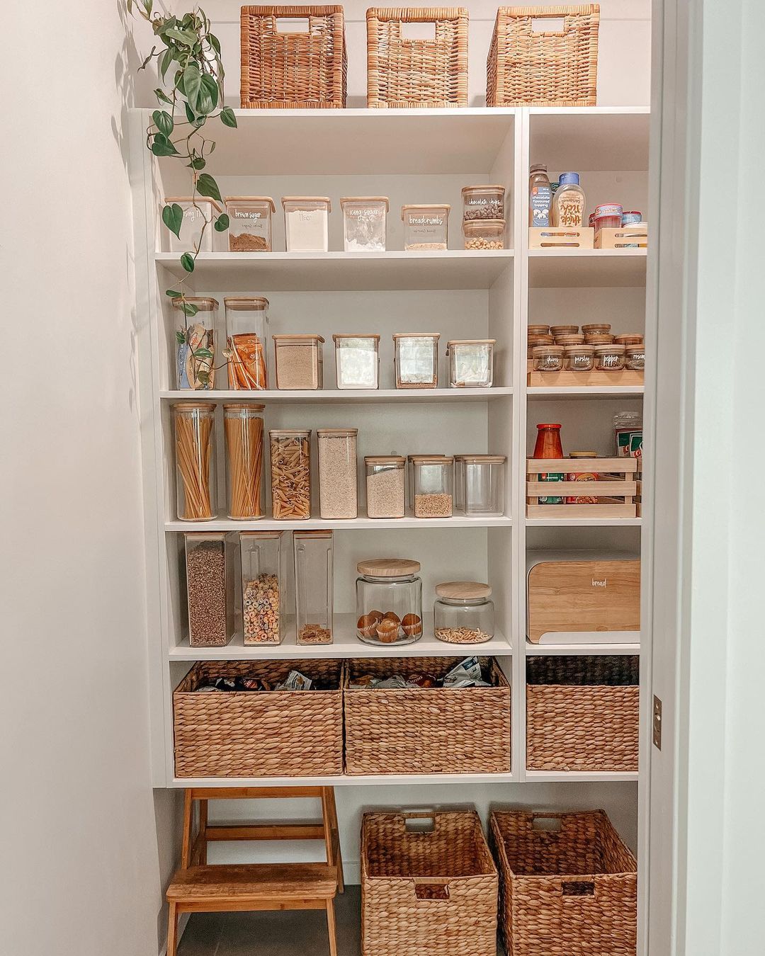 Looking to organize a small pantry efficiently? Consider utilizing white pantry with wicker baskets for storage.