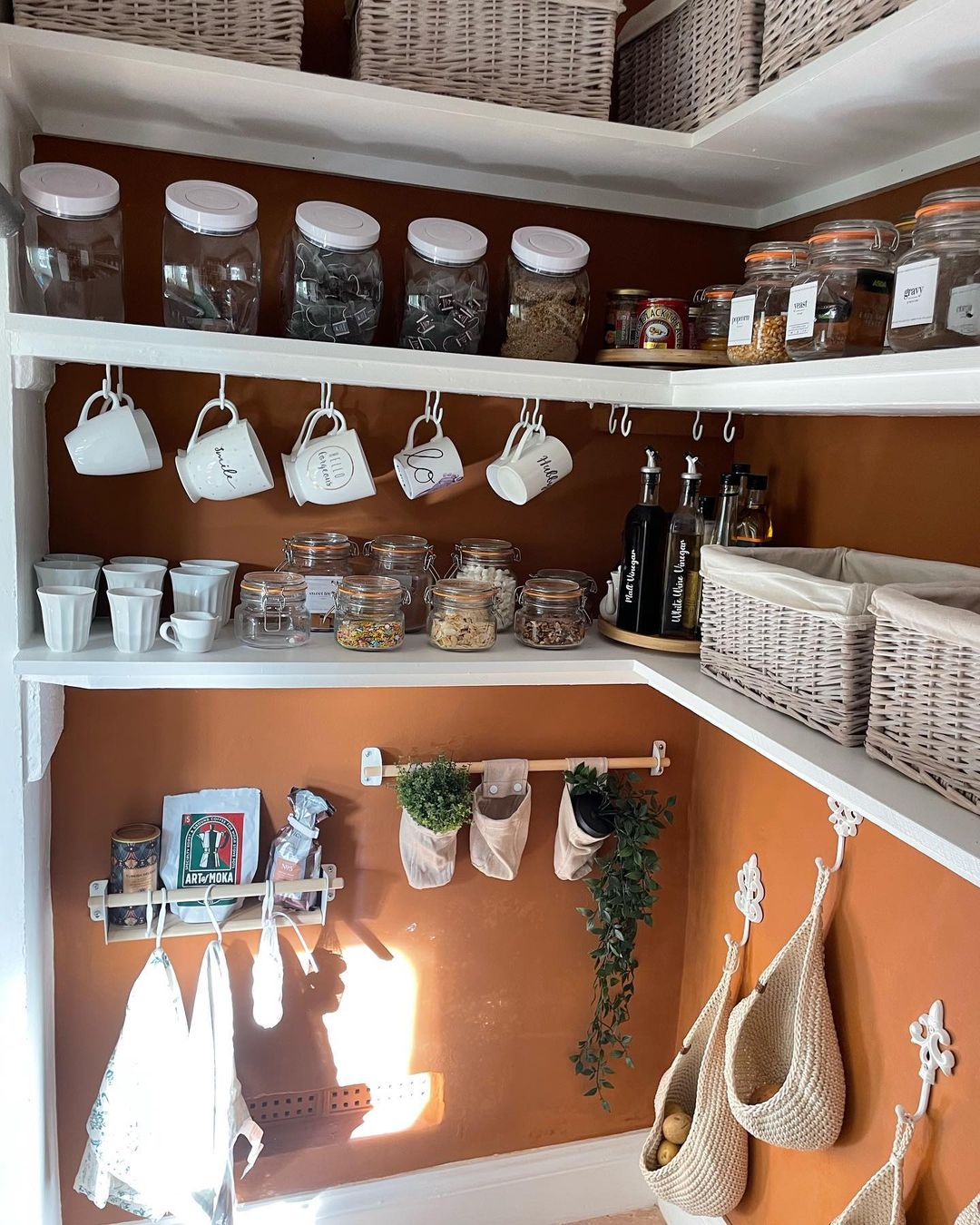 A kitchen with shelves filled mainly with pots.