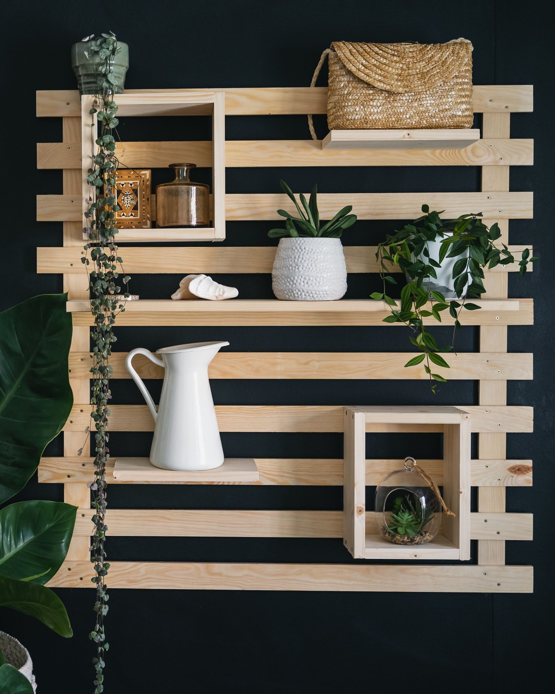 a unique wooden shelf is a clever and efficient way to use a wall as decorative display of personal and cherished items.