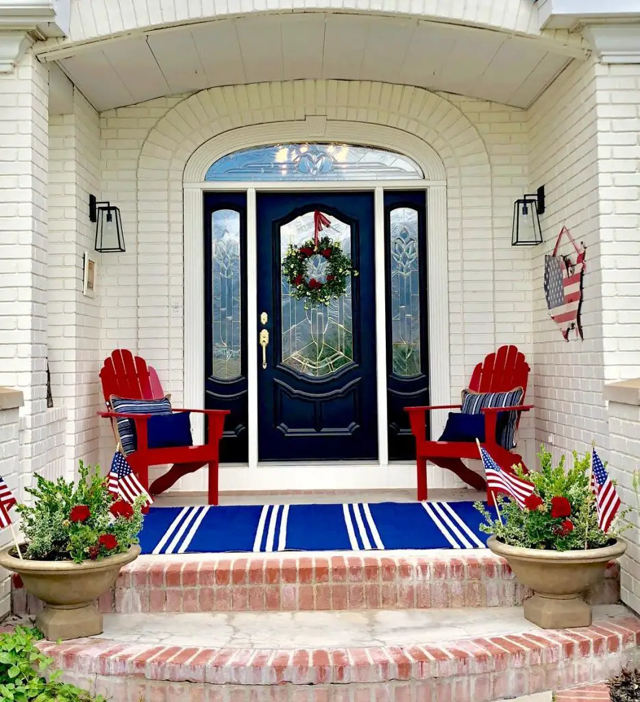 fourth of July front porch decor showcasing two wooden chairs and potted plants styled in red, blue, and white