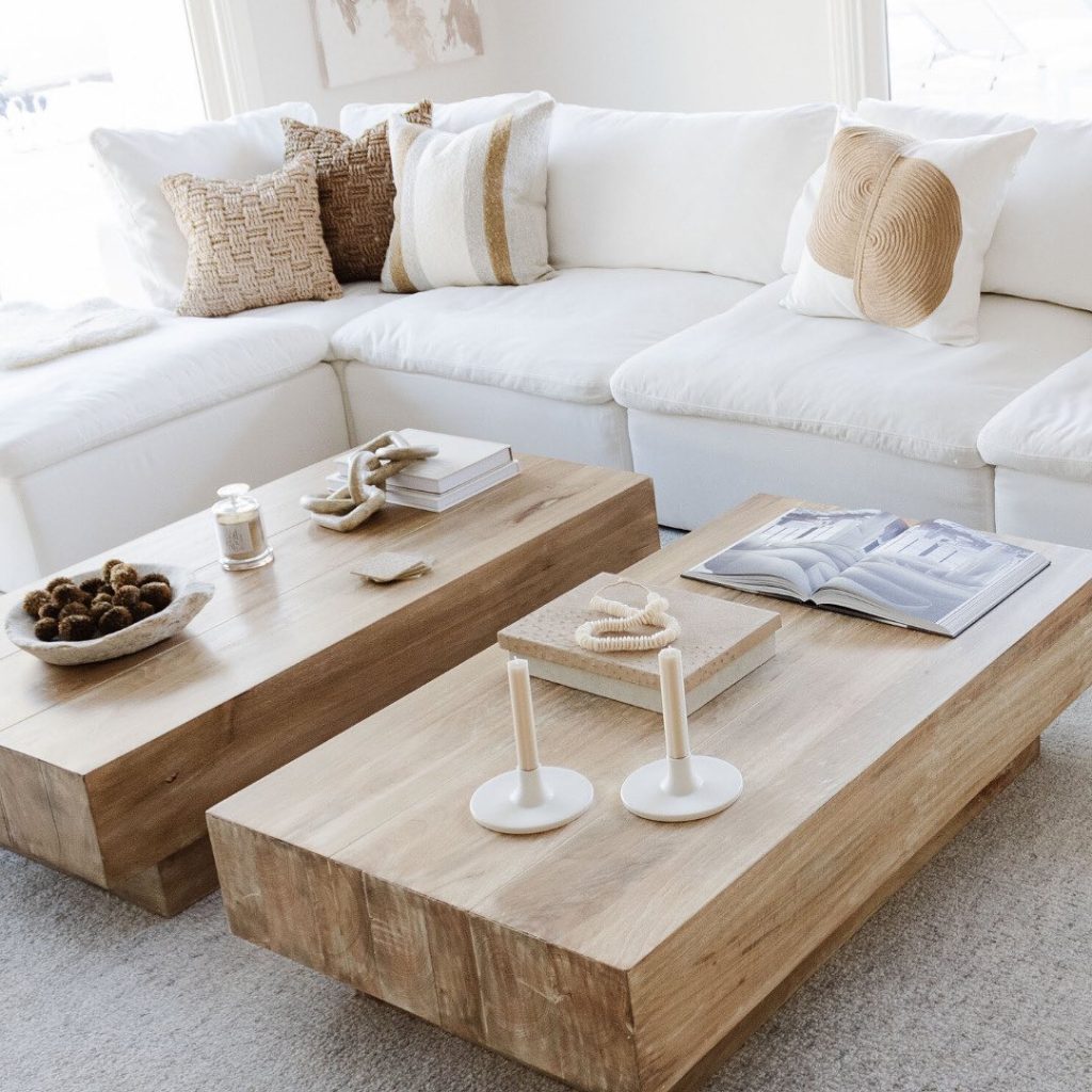 white sectional with two wooden coffee tables in a minimalist style living space