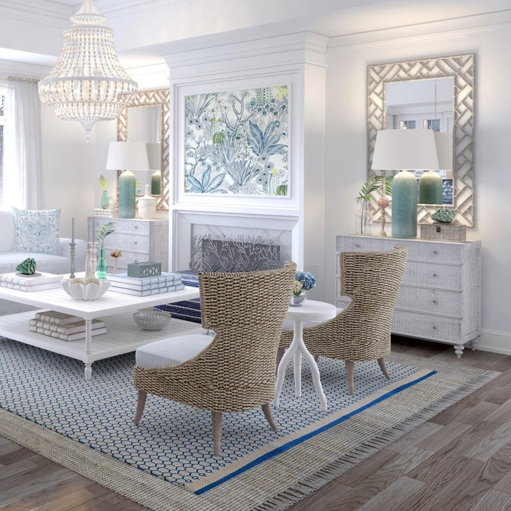 Elegant coastal-inspired living room with wicker chairs, white sofa, chandeliers, and ocean-themed decor.