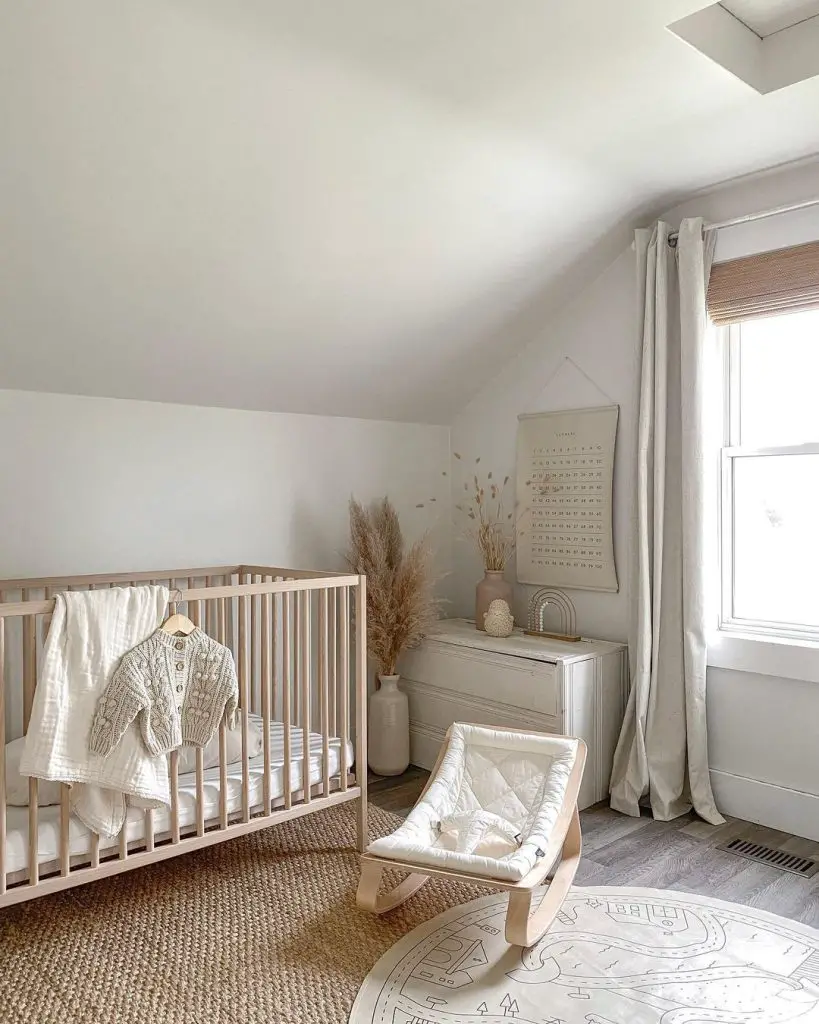 A serene nursery room with a light wood crib, white rocking chair, and decor in bohemian-inspired neutral tones. Natural light streams through a window.