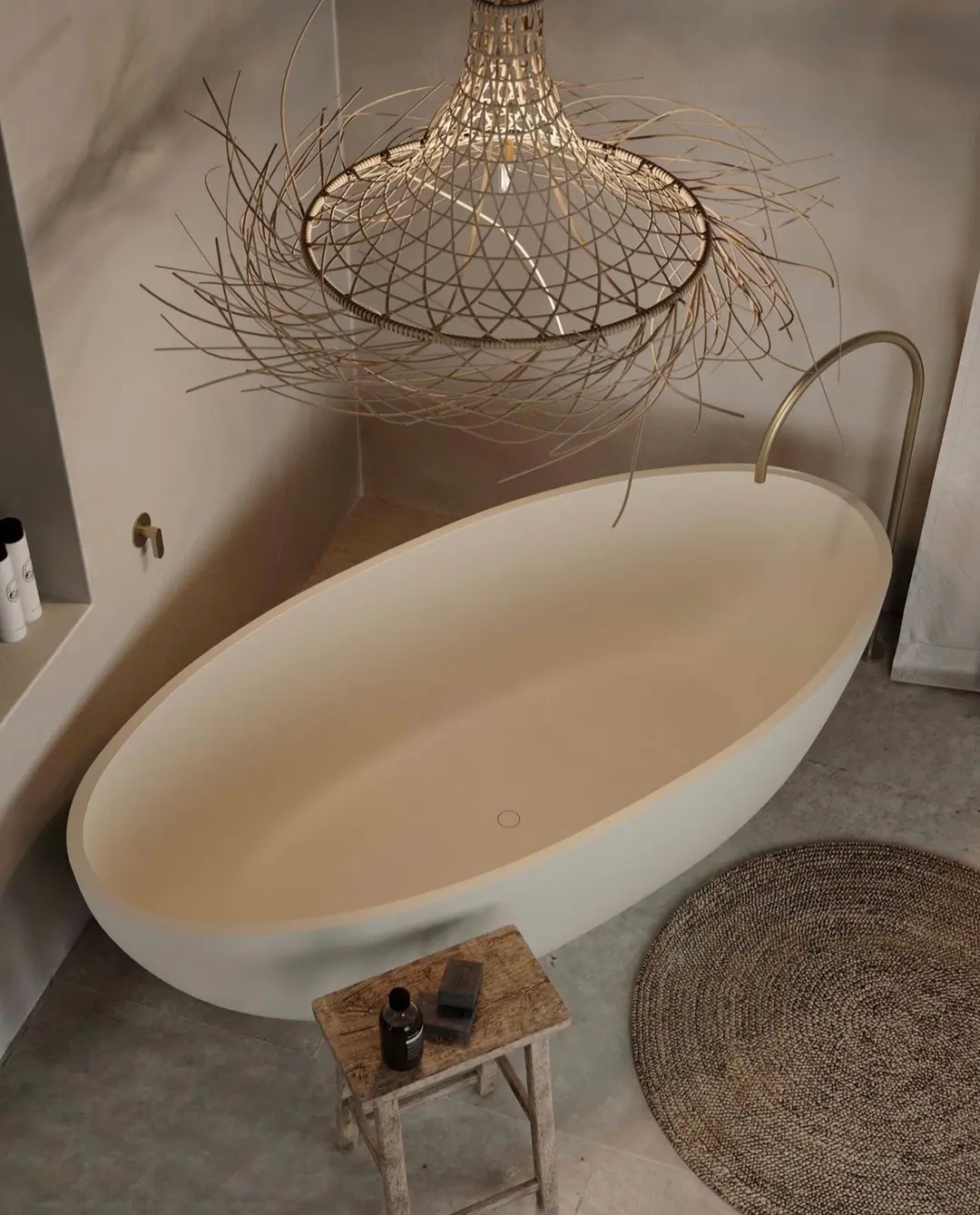 A Coastal Boho Bathroom features a freestanding oval bathtub, a wicker chandelier, a small wooden stool with toiletries, and a round woven rug on the floor—creating a serene retreat.