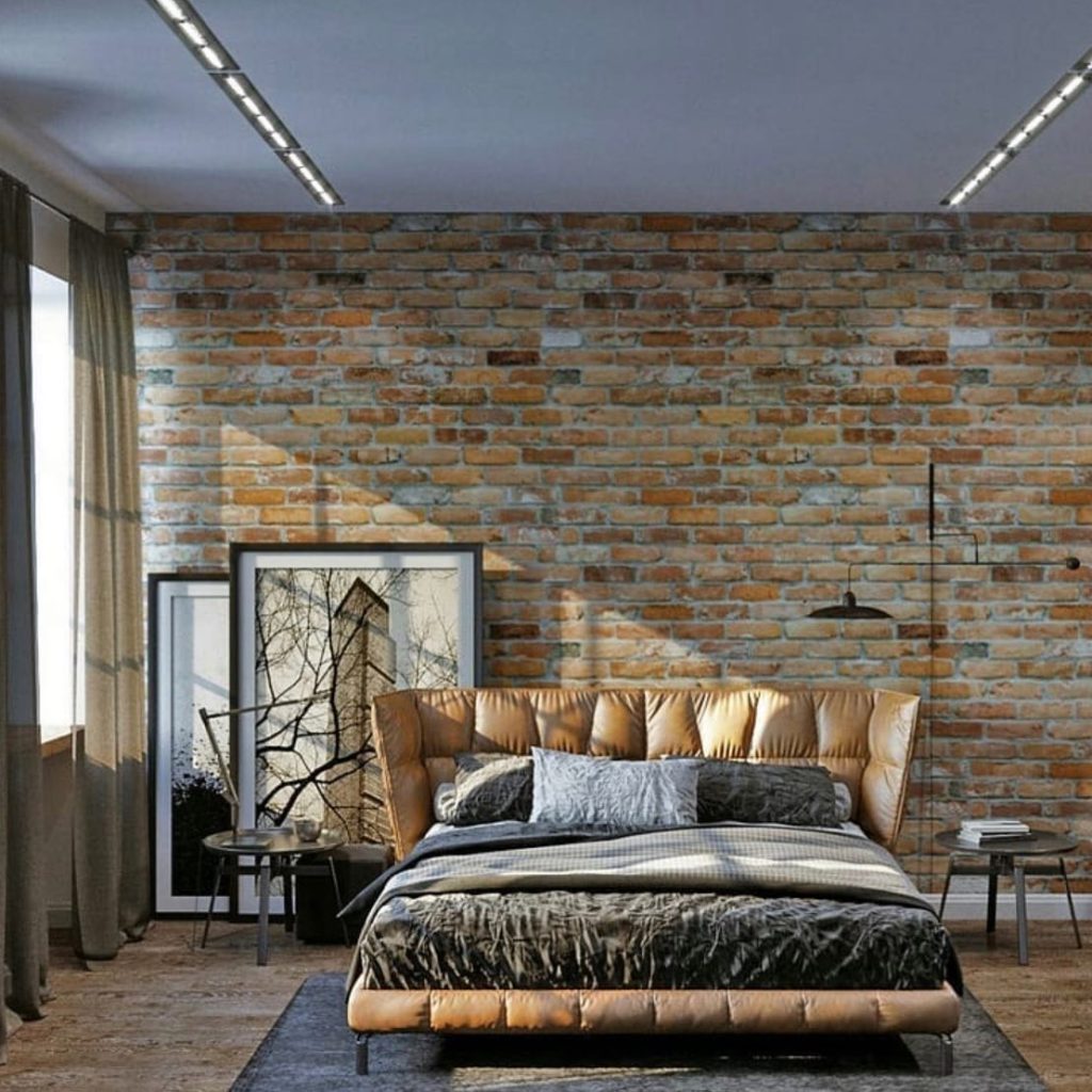 Modern industrial bedroom with a brick wall, queen-sized bed with tufted headboard, and LED ceiling lighting.