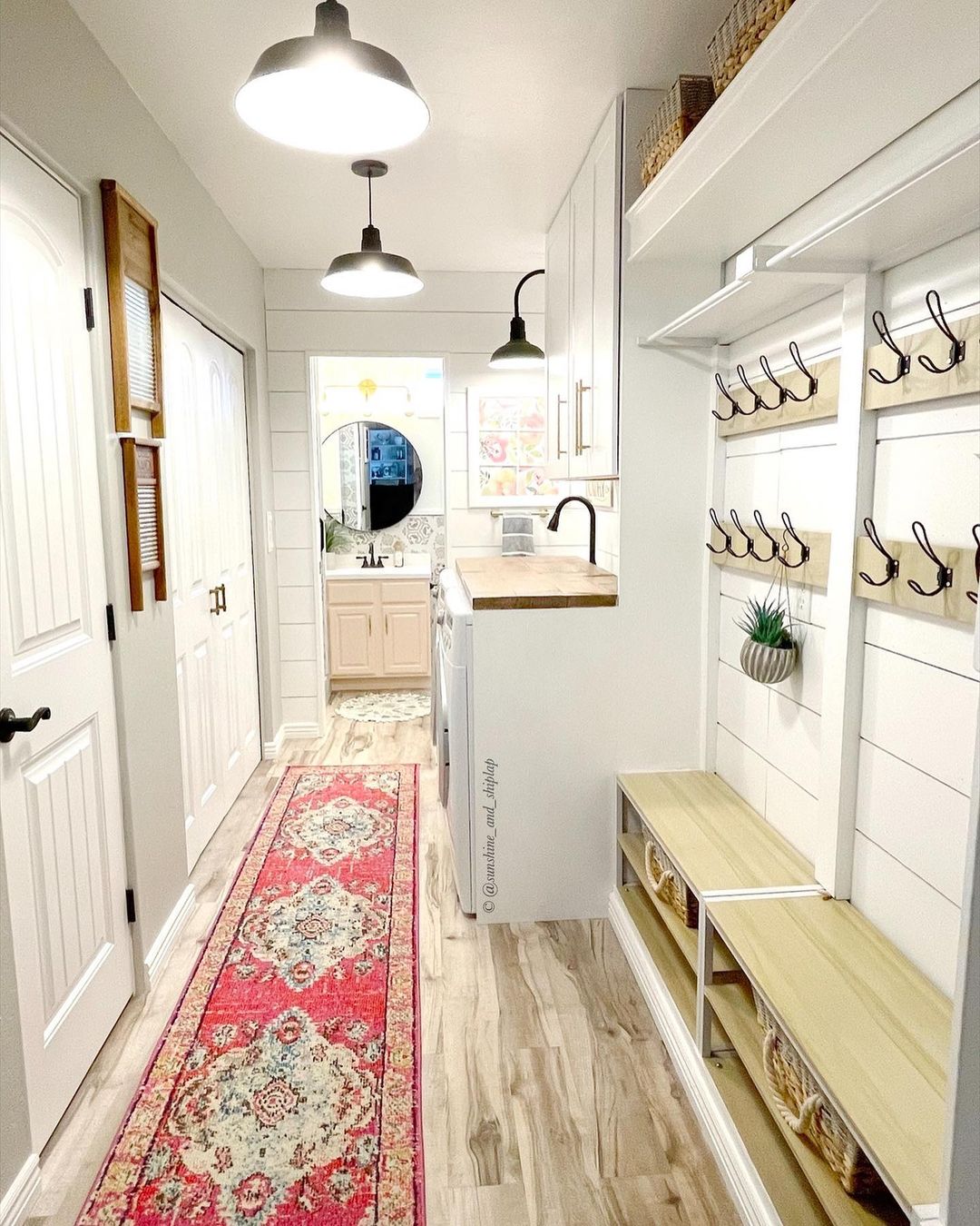 to maximize space in your long narrow laundry room, make use of vertical wall space by installing hooks for hanging items such as bags, decorative items, and of course, clothes.