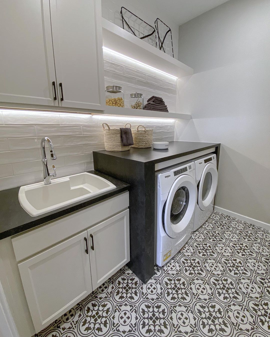 one way to maximize space in your long narrow laundry room is to be smart about incorporating lighting in awkward or difficult to reach spots such as under wall cabinets and shelves.