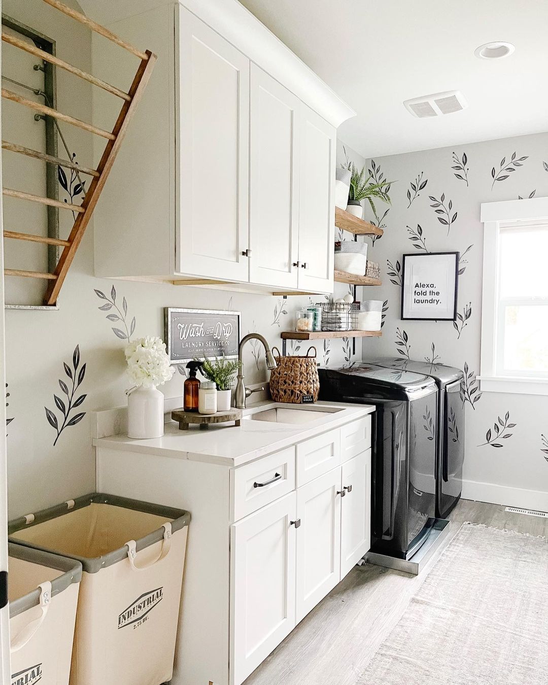 To maximize your long narrow laundry room, make sure to use every available vertical space on walls by installing custom wall cabinets and open shelving.