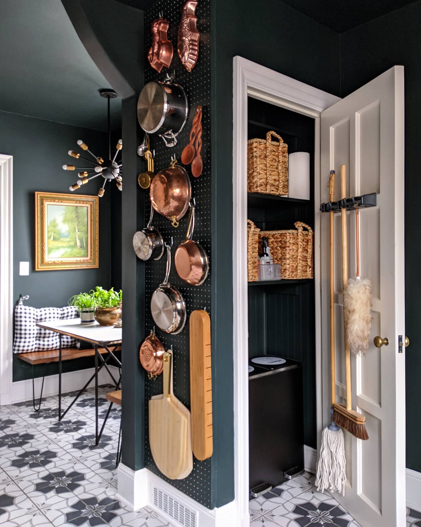 an unused wall installed with a pegboard to hold pans and pots can be a great way to store such items while creating a unique wall gallery.