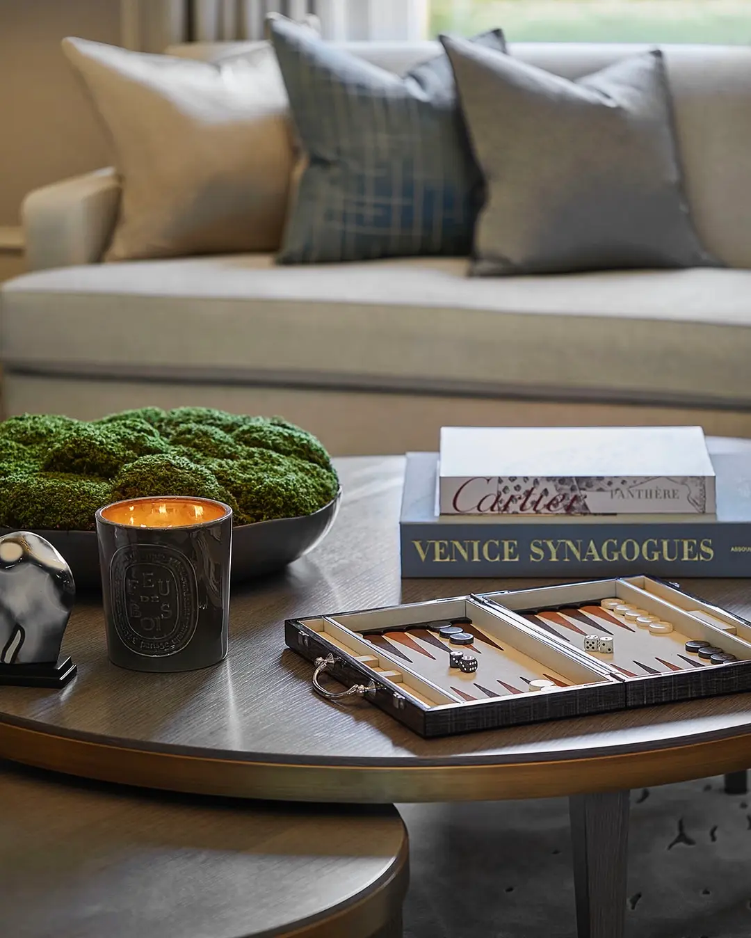 styling a coffee table can be as simple as using personal items or interest such as a game board.