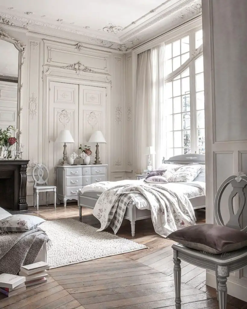 gorgeous french country furnished bedroom with a bed next to a large window