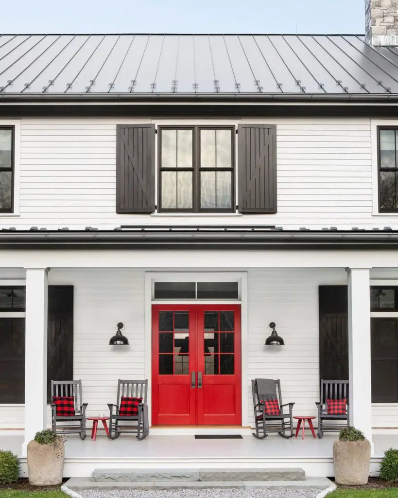 stunning red double front doors enhancing the curb appeal of a white painted two-storey home