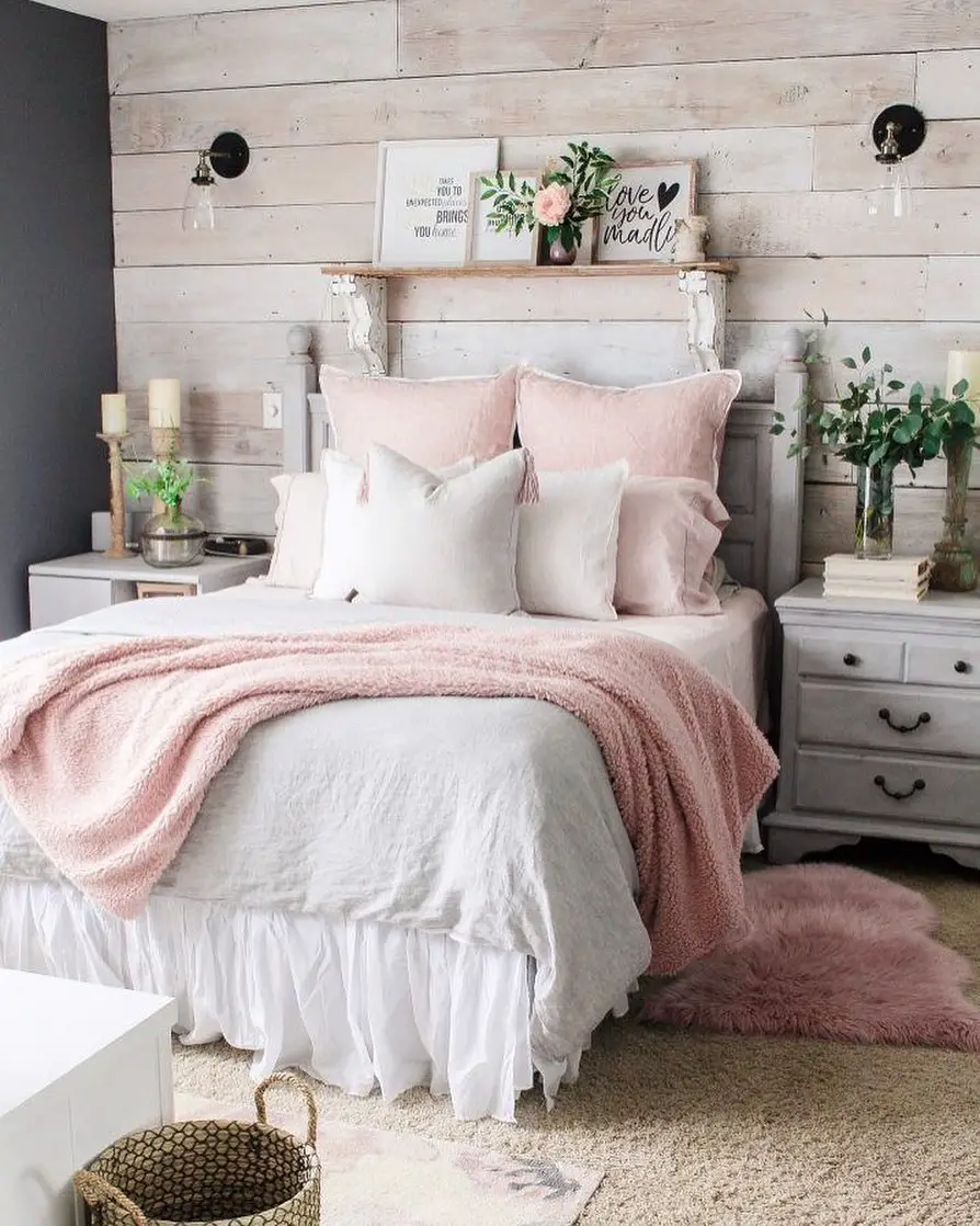 beautiful white, grey, and pink bedding in this cozy carpeted bedroom 