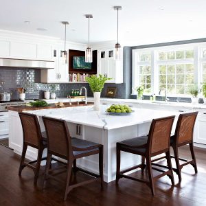 transitional kitchen with a large centre island with four dining chairs