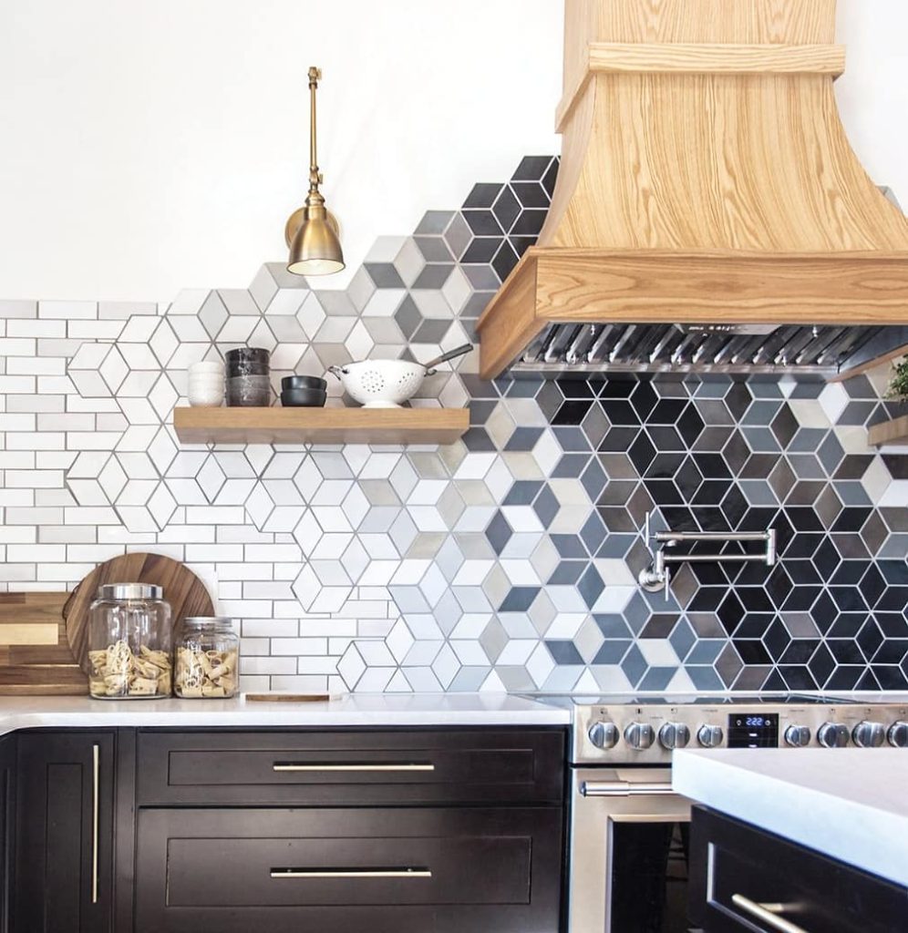 kitchen with geometric backsplash tiles, range and hood, and an open shelf