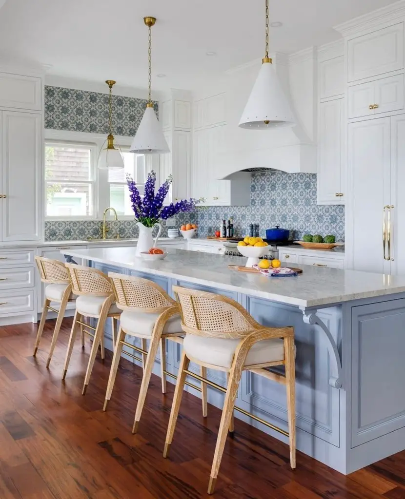 coastal style kitchen with a pale blue island and wicker back wood seatings