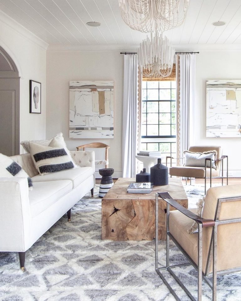 transitional style living room showcasing modern looking furniture including a white couch and a wooden coffee table