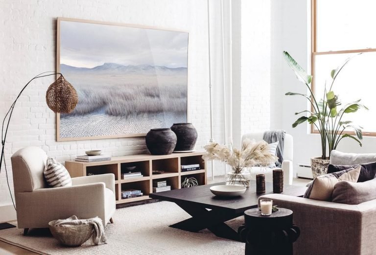 modern style living room with wall art, low shelf unit, sofas and a square wood coffee table