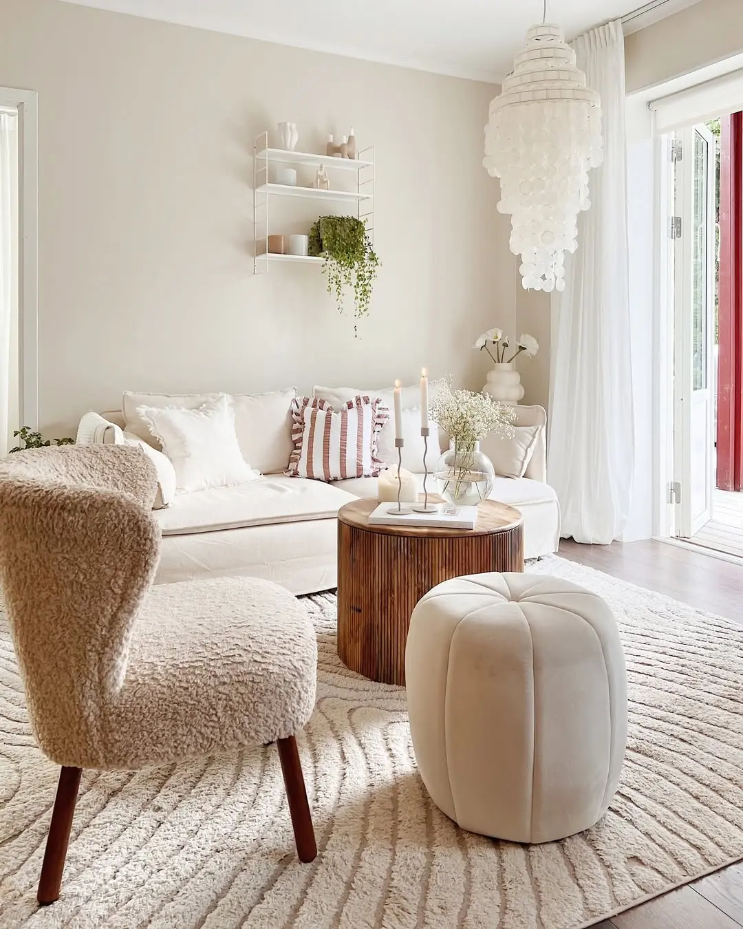 a bright living room interior with scandinavian influence including furniture, greenery and no clutter makes this space functional and an extension of the exterior