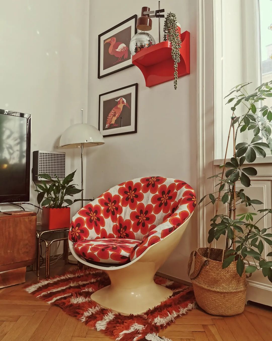 retro style chair with bold red colored upholstery to create a focal point in this living space