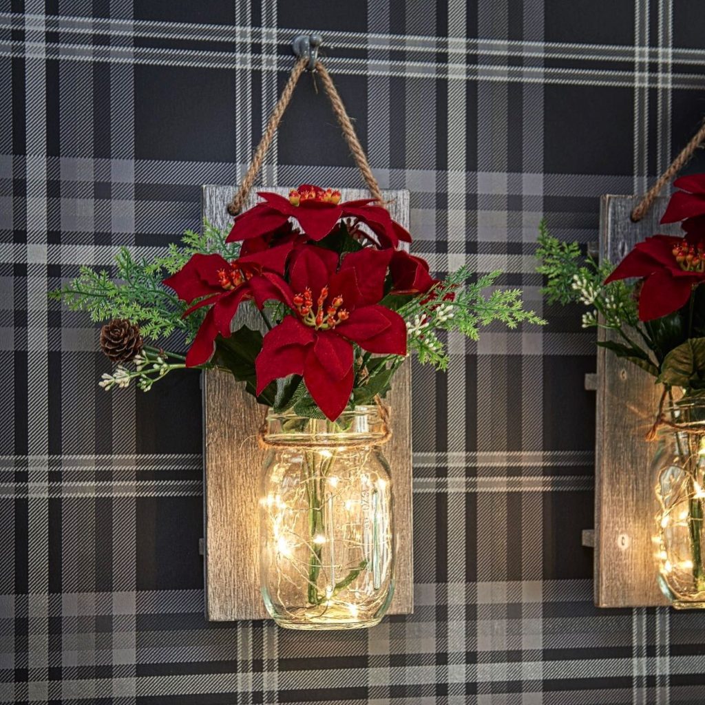 Hanging Mason Jars with string lights inside and red flowers