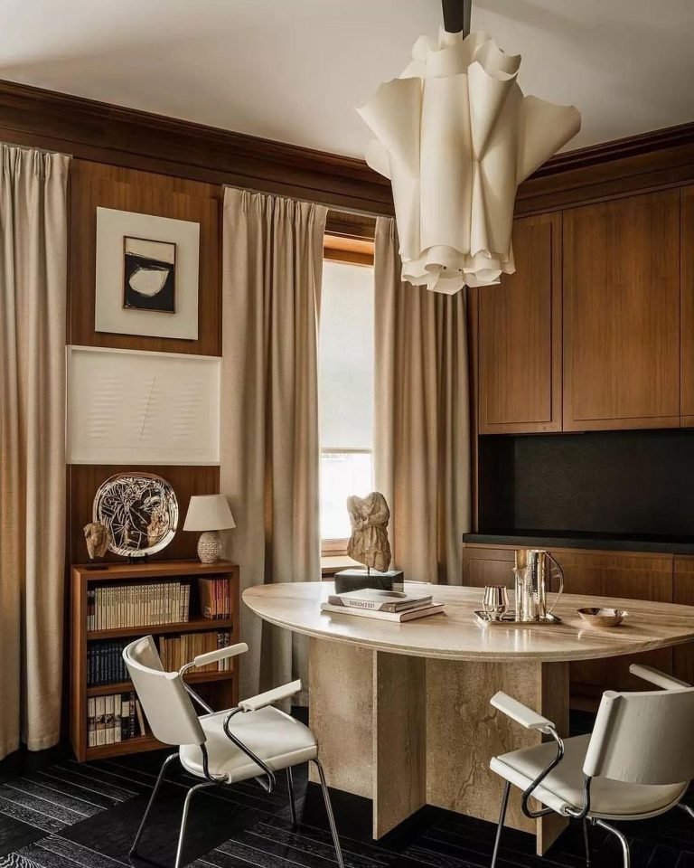 dining room with a round table, two chairs, and an unusual ceiling light