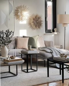 living space with a neutral color palette showcasing throw pillows and blankets on a sectional ideal for winter decor