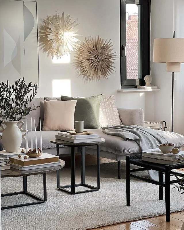 living space with a neutral color palette showcasing throw pillows and blankets on a sectional ideal for winter decor