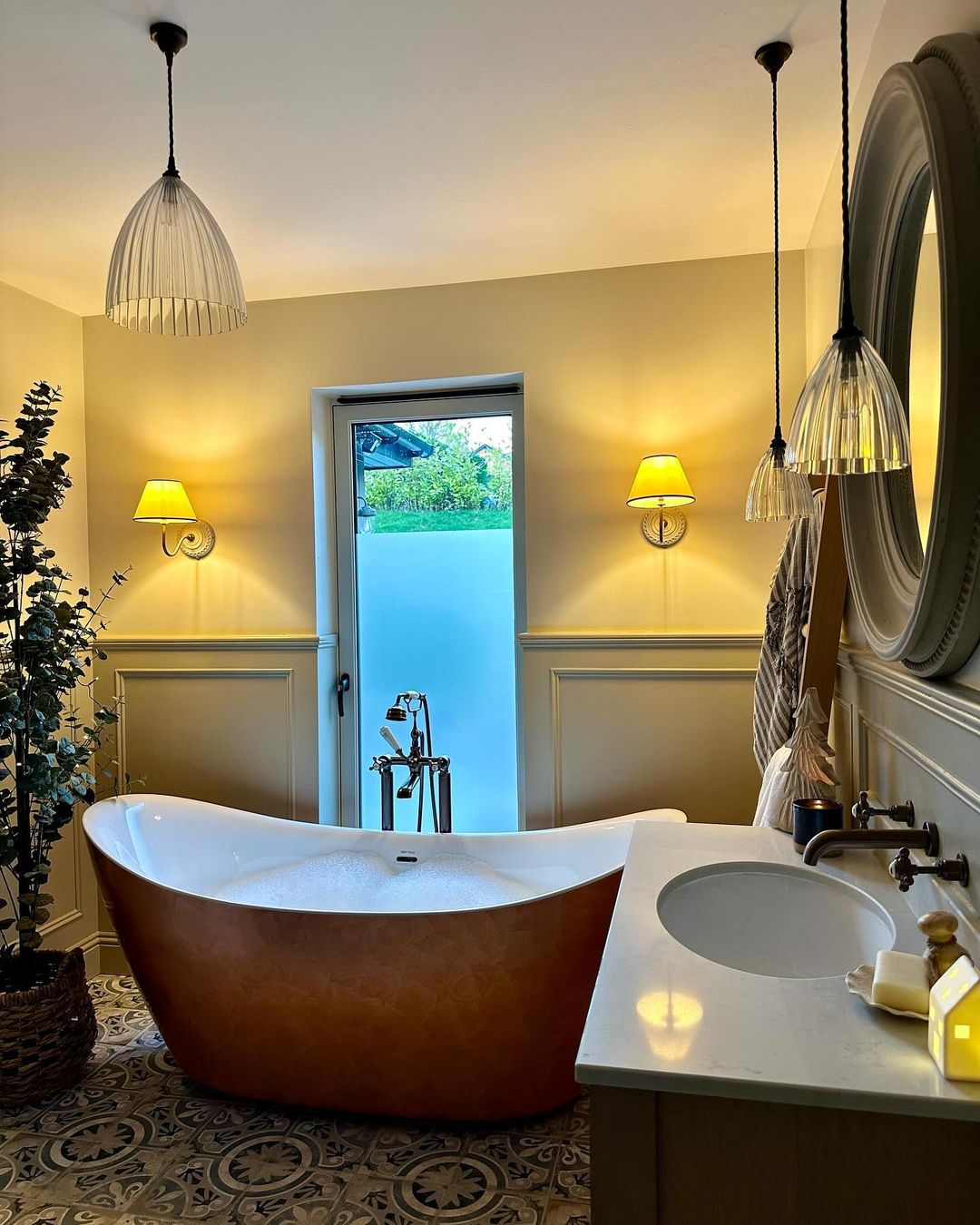 bathroom with a freestanding tub, vanity and rustic-inspired lighting