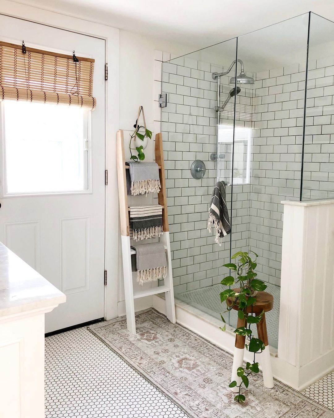 a bathroom towel rack repurposed from an old wooden ladder in a bathroom provides ample towel storage while impacting as little floor space as possible