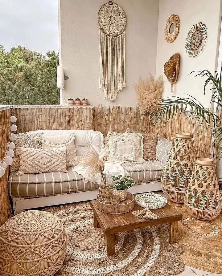 a balcony with outdoor furniture including seatings and coffee table styled with bohemian -inspired throw pillows and wall decor 