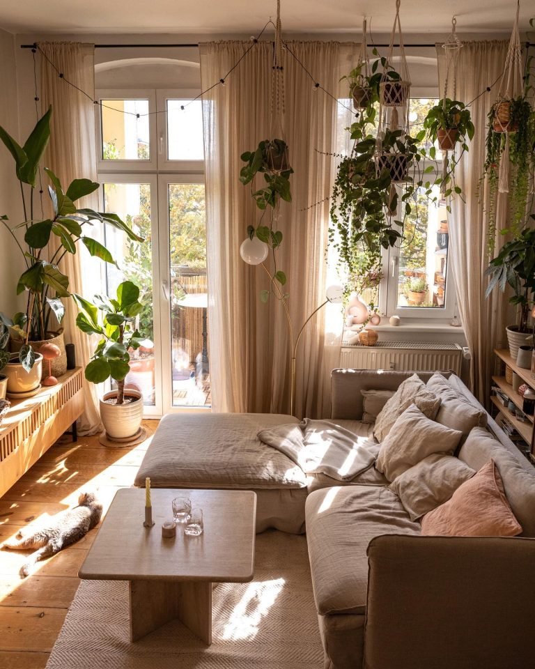 living room decorated with greenery, wooden furniture and lots of texture including area rug and throw pillows