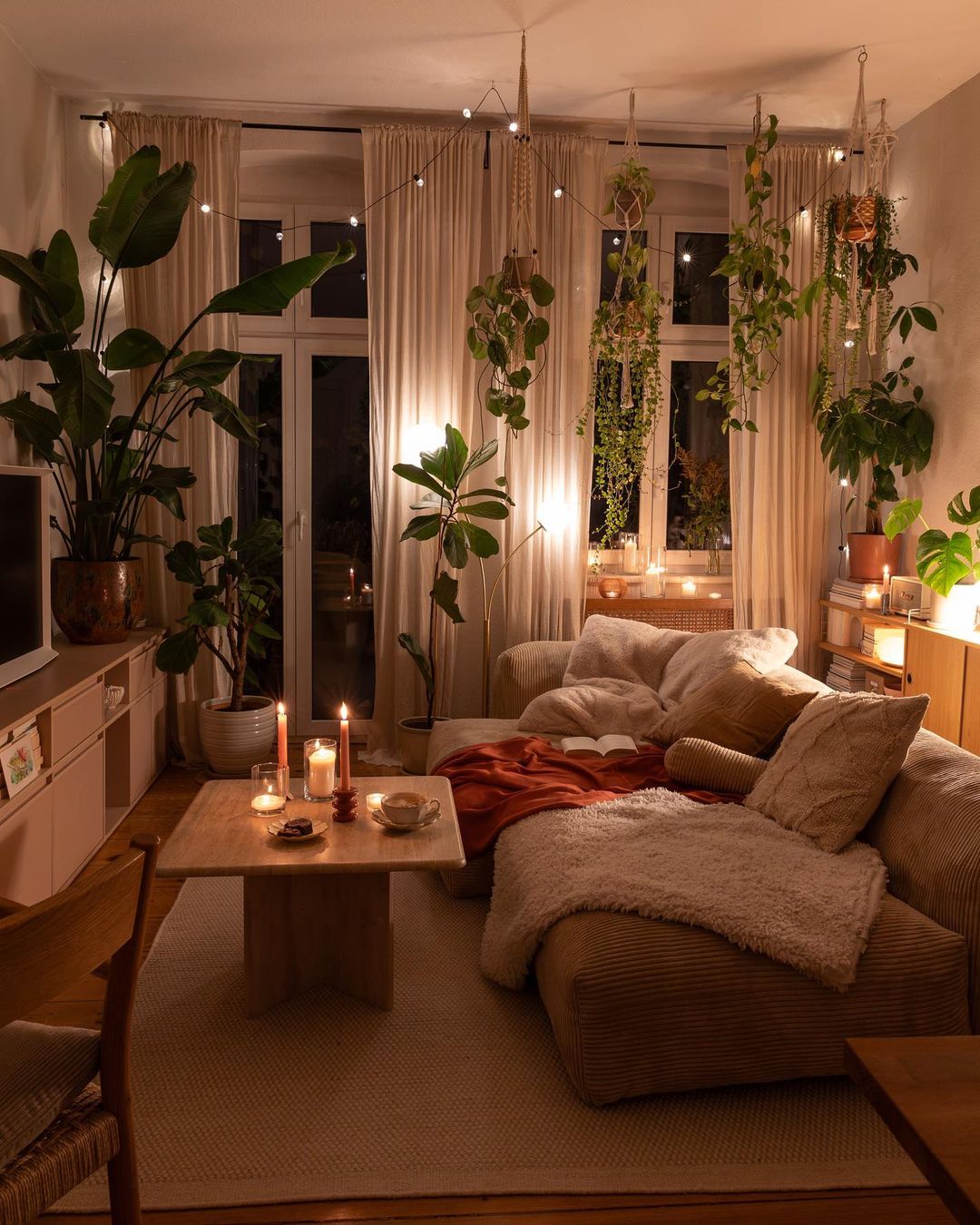 a living room with bohemian-inspired decor including greenery, candles, and lots of textiles can be used to decode the secrets of bohemian decor.