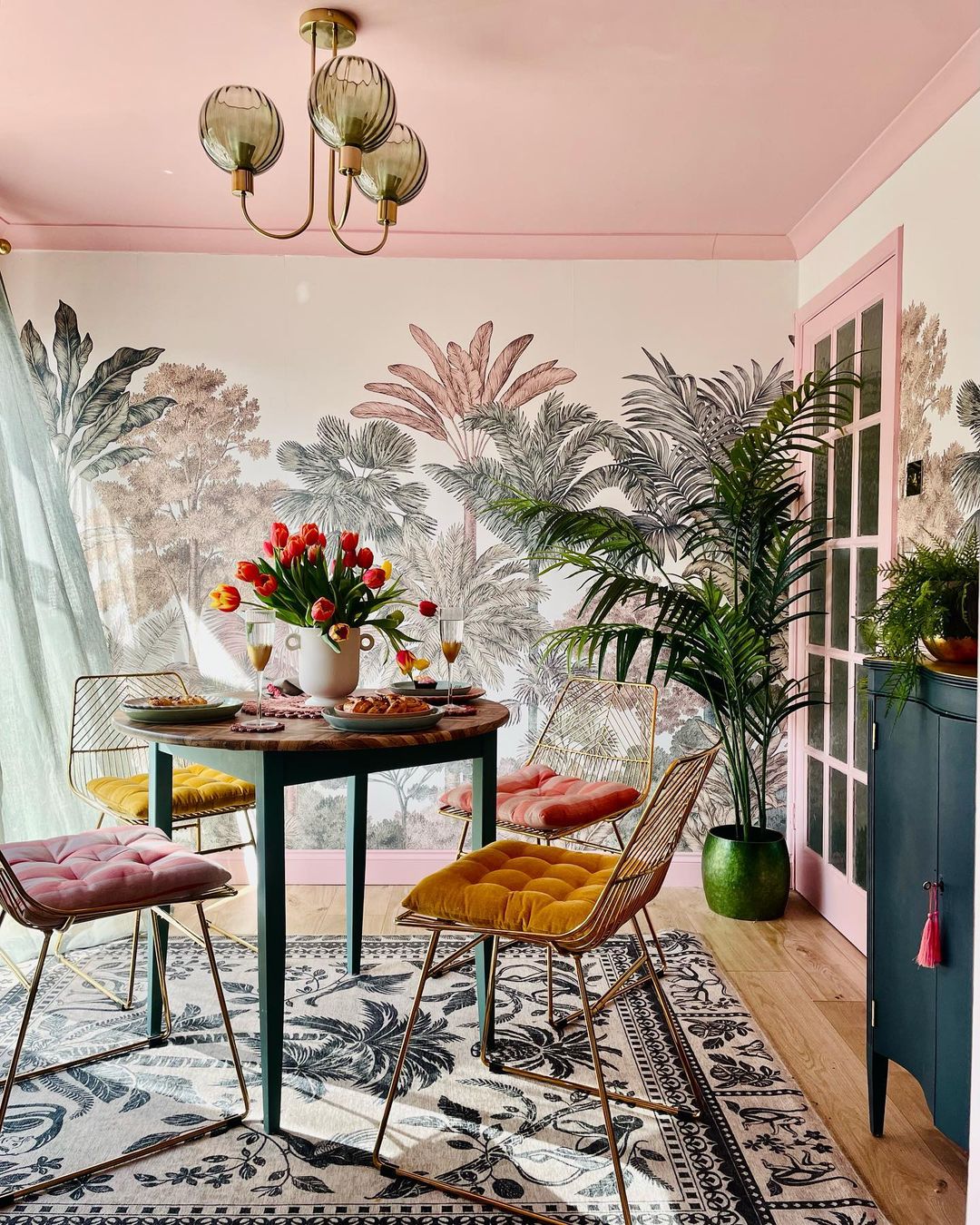 mixing different vibrant colors, a richly decorated wallpaper, and a potted green plant is all that's needed to create an uplifting interior