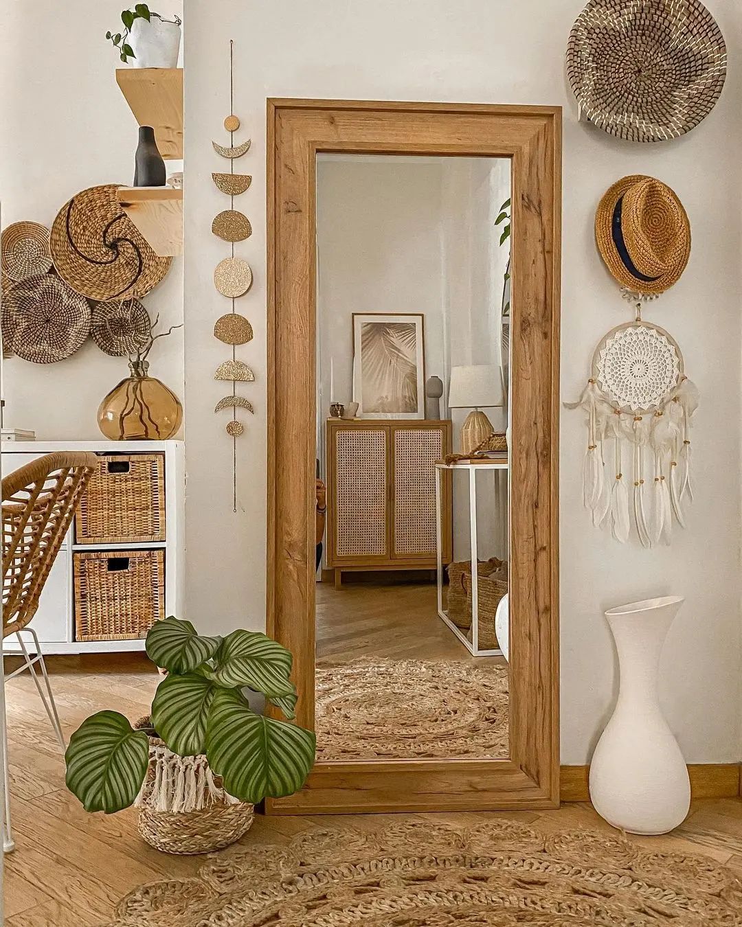 hats and baskets add visual interest and texture to this bohemian-inspired living area wall 