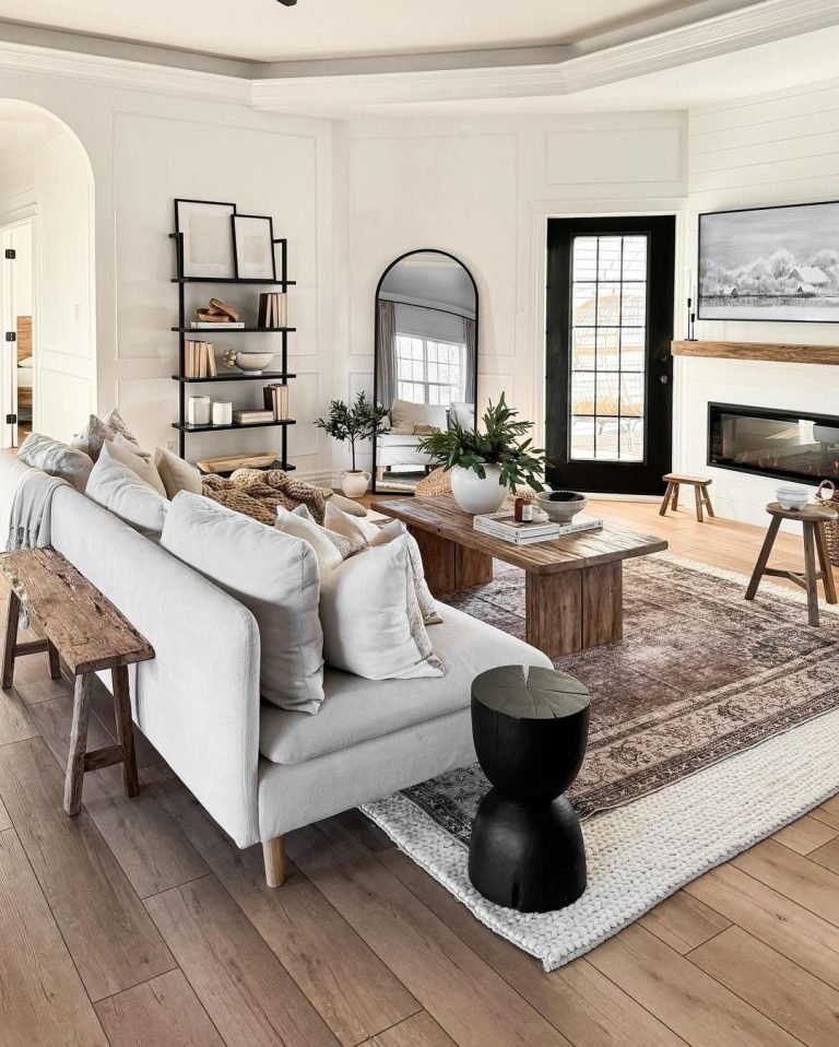 a couch and acoffee table anchored with floor rugs are the focus in a well decorated living room like this one which can be achieved on a budget.