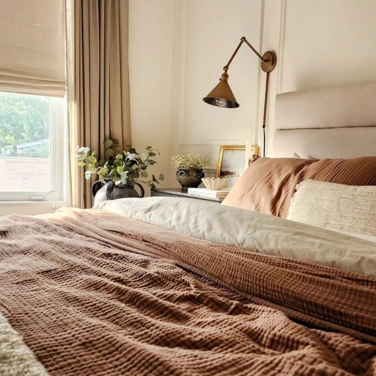 a metal wall sconce in the farmhouse style is the perfect accent piece for this bedroom