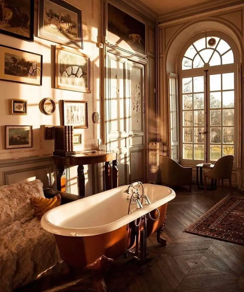 a generous french country bathroom with a freestanding tub and a wall gallery letting the sunset rays in epitomize the essence of french country decor