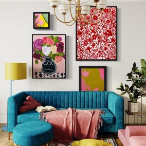 funky framed wall art on a back living room wall behind a colorful couch is the perfect combination for a vibrant and funky interior.