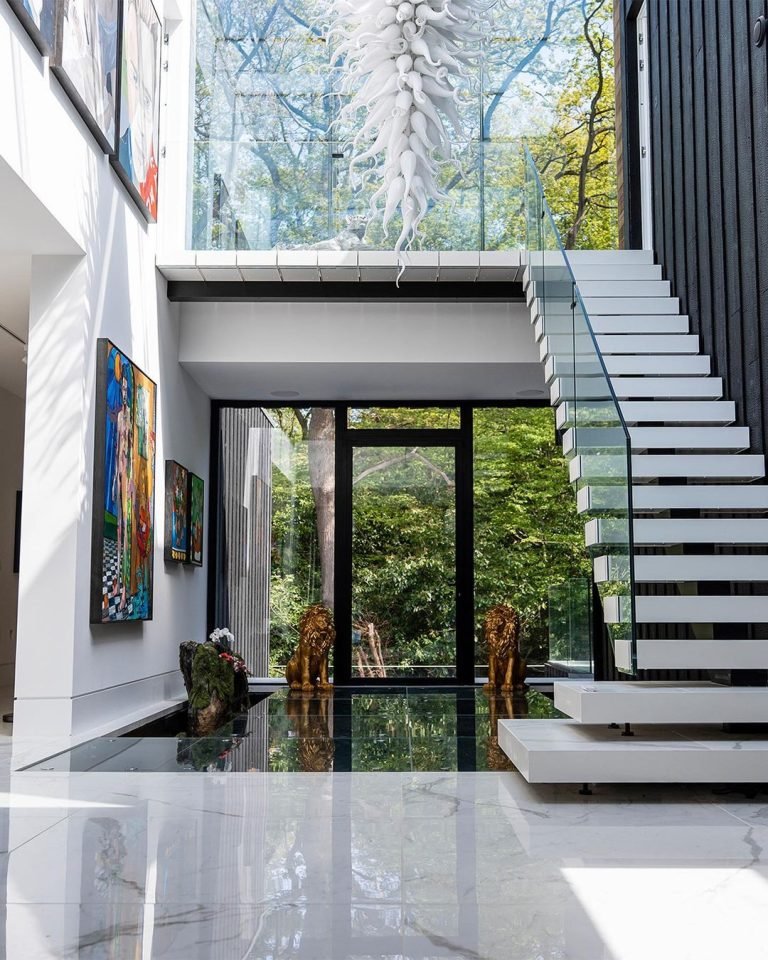 the interior of a house with a stair and a pond next to it to enhance the natural feel of this modern interior