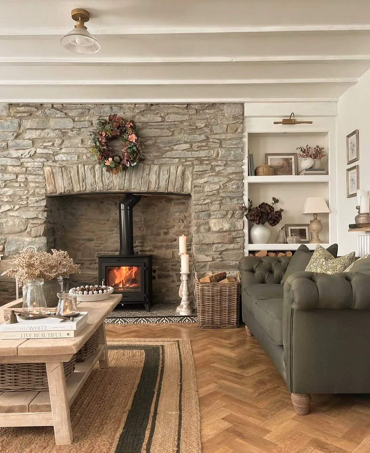 modern cottage style living room with a stone facing fireplace and living room furniture