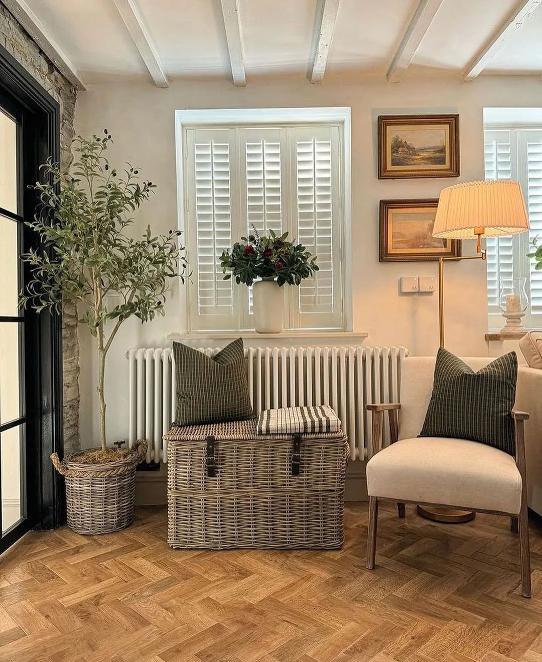 furniture including a chair and storage box styled with throw pillows in a modern cottage style living area