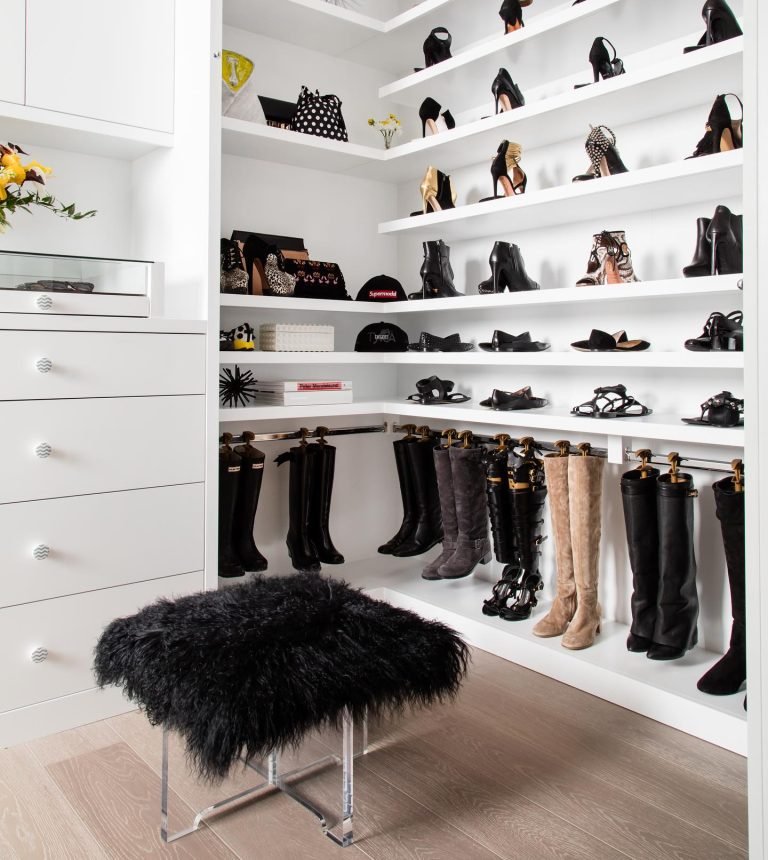 a dedicated shoe closet space with open shelves and a boots rod to hang boots is a great way to organize shoes.