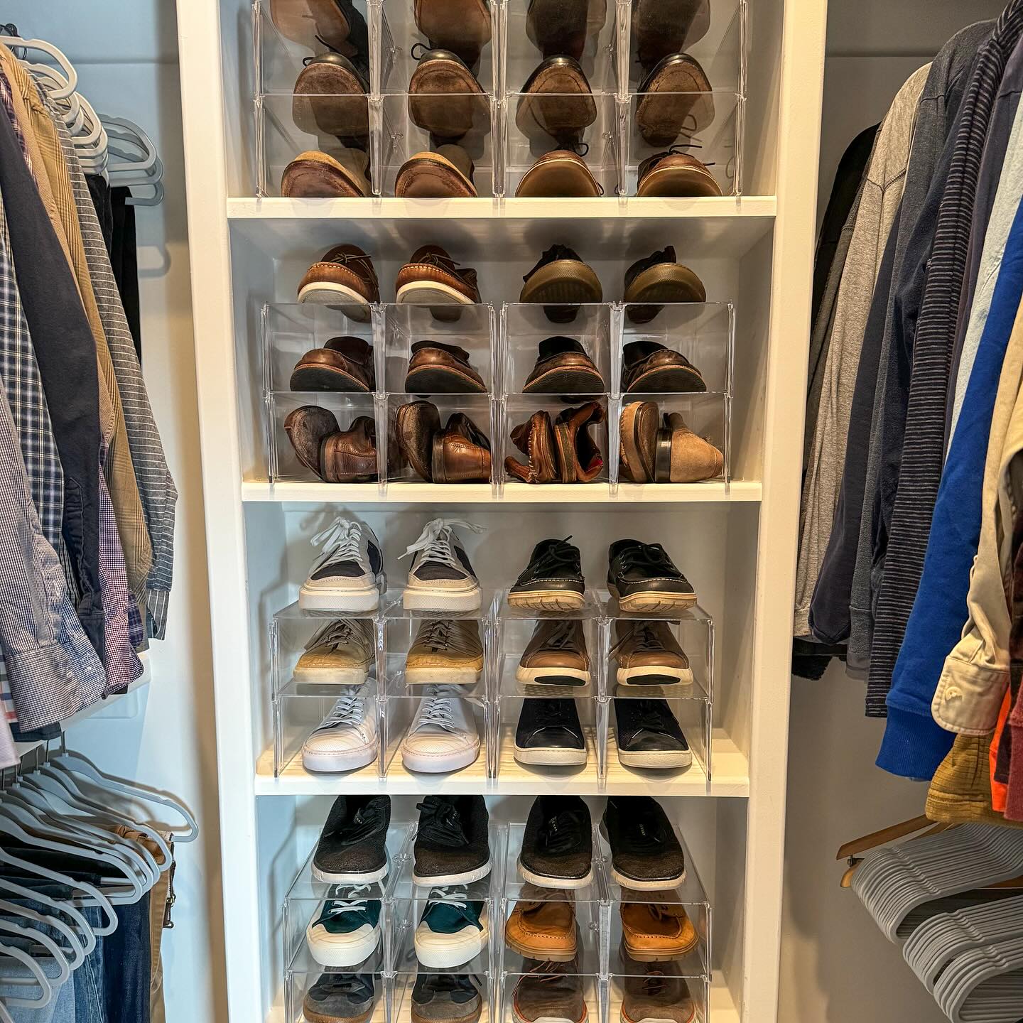 acrylic stacking shoe bins in a walk-in-closet for maximizing storage & keeping shoes well organized.