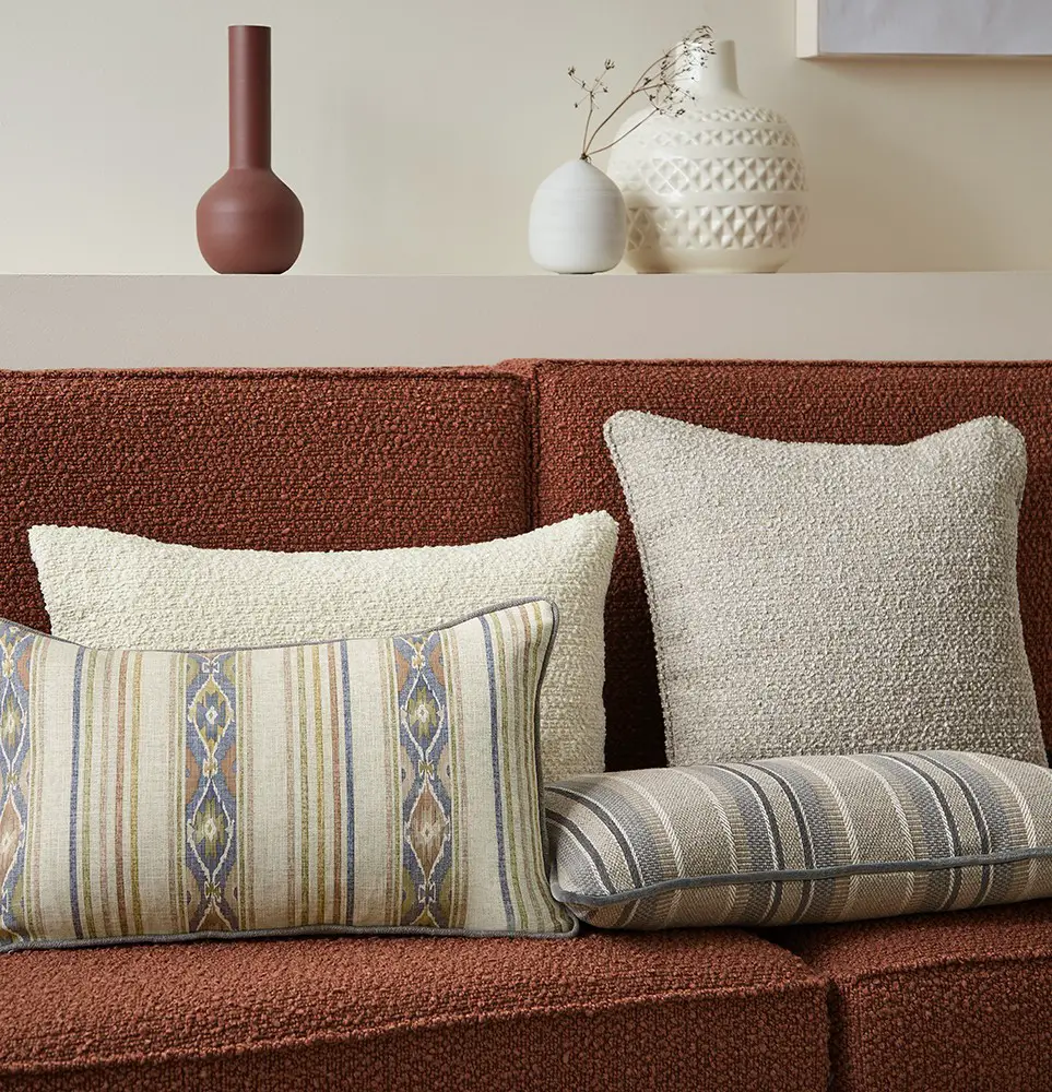 textured fabric add visual and tactile beauty to this couch styled with textured throw pillows