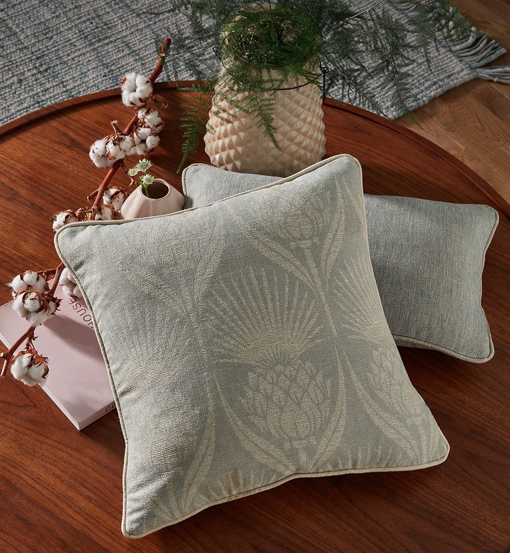 textured throw pillows on a wooden coffee table styled with other decor accents