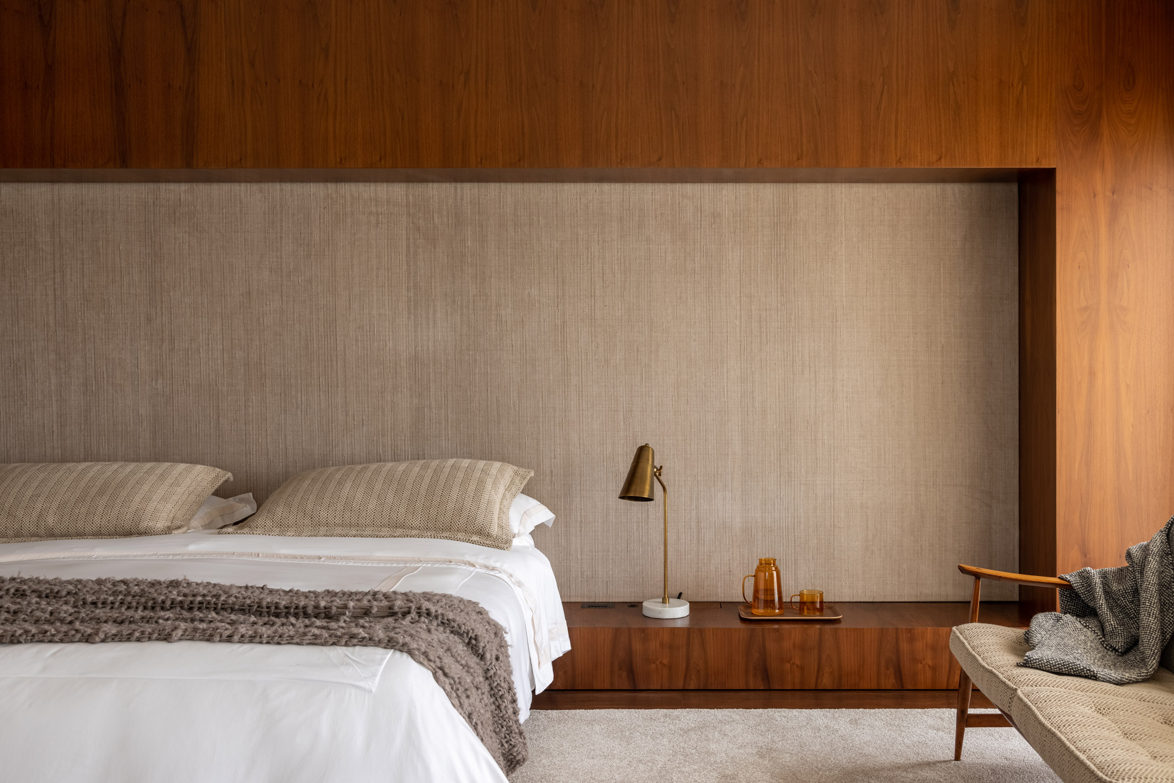 warm wooden panels create a rich backdrop in this bedroom while adding a calming influence of earthy tones to the room.